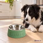 Sage-green personalised ribbed bowl riser on a kitchen floor beside a black-and-white dog.