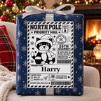 Christmas Cat North Pole sticker personalised with Harry, shown on a wrapped Christmas gift.