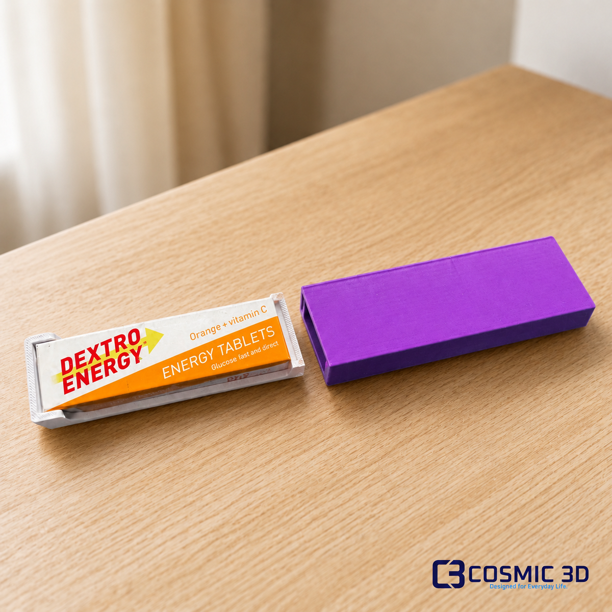 Purple Dextrose tablet holder with wrapped Dextro Energy strip beside it on a light wood surface